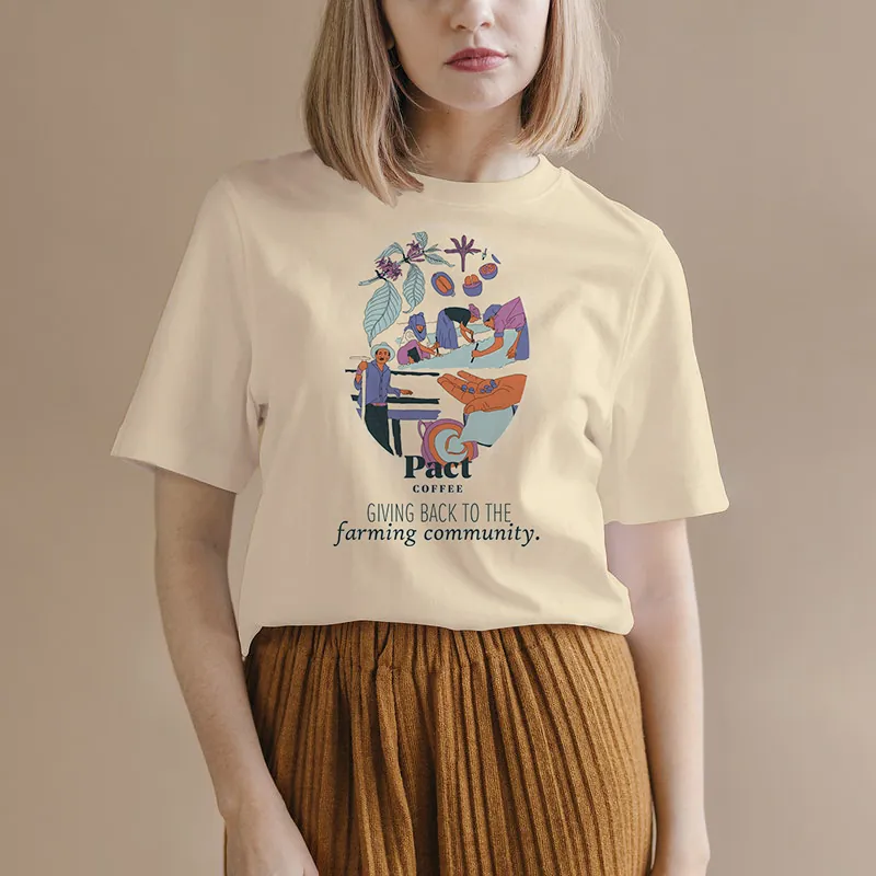 Person wearing a cream Pact Coffee t-shirt printed with the campaign artwork